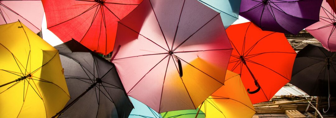Lots of coloured umbrelllas to represent the different types of protection cover and choices